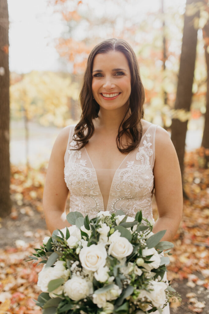 the beautiful bride in her white-laced wedding gown smiling