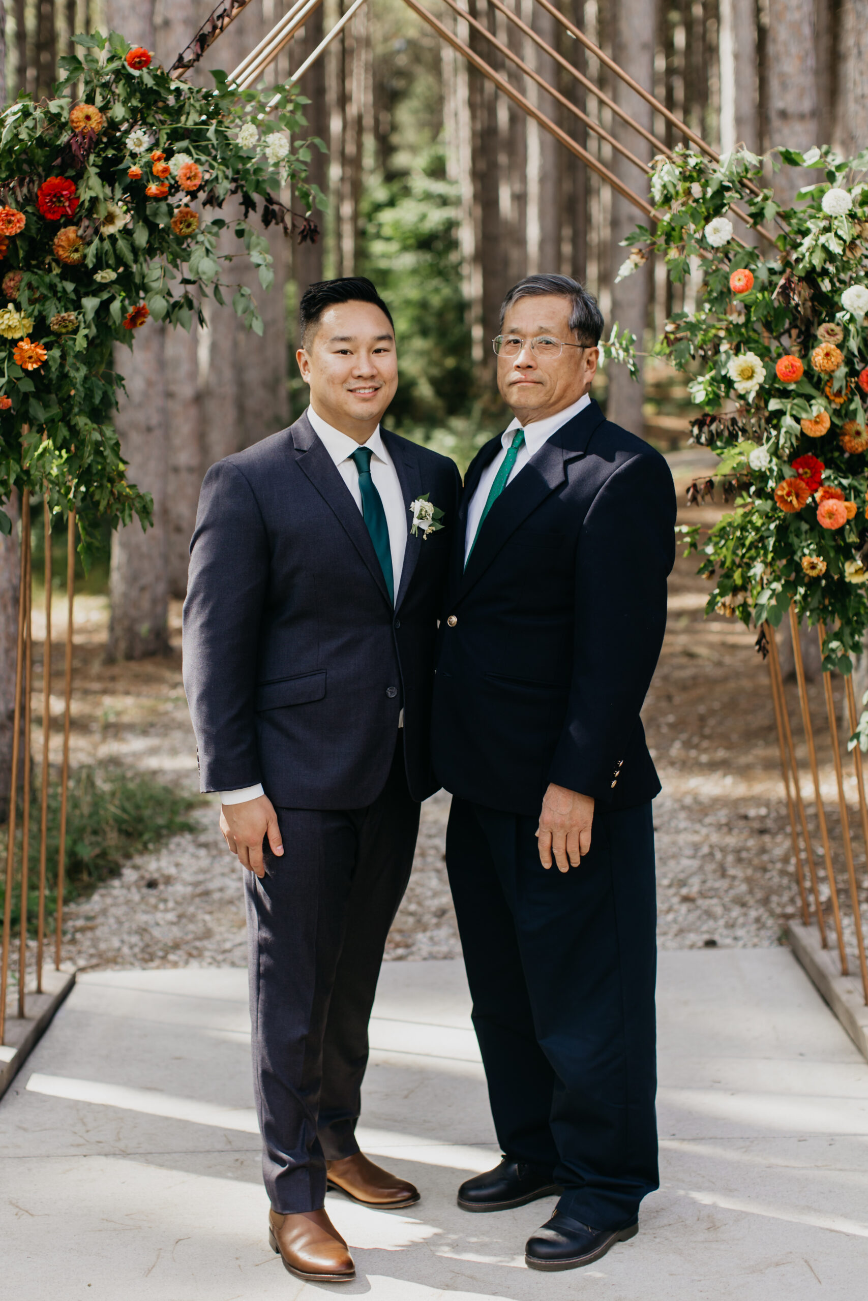 A photo of the groom and his father during the wedding ceremony
