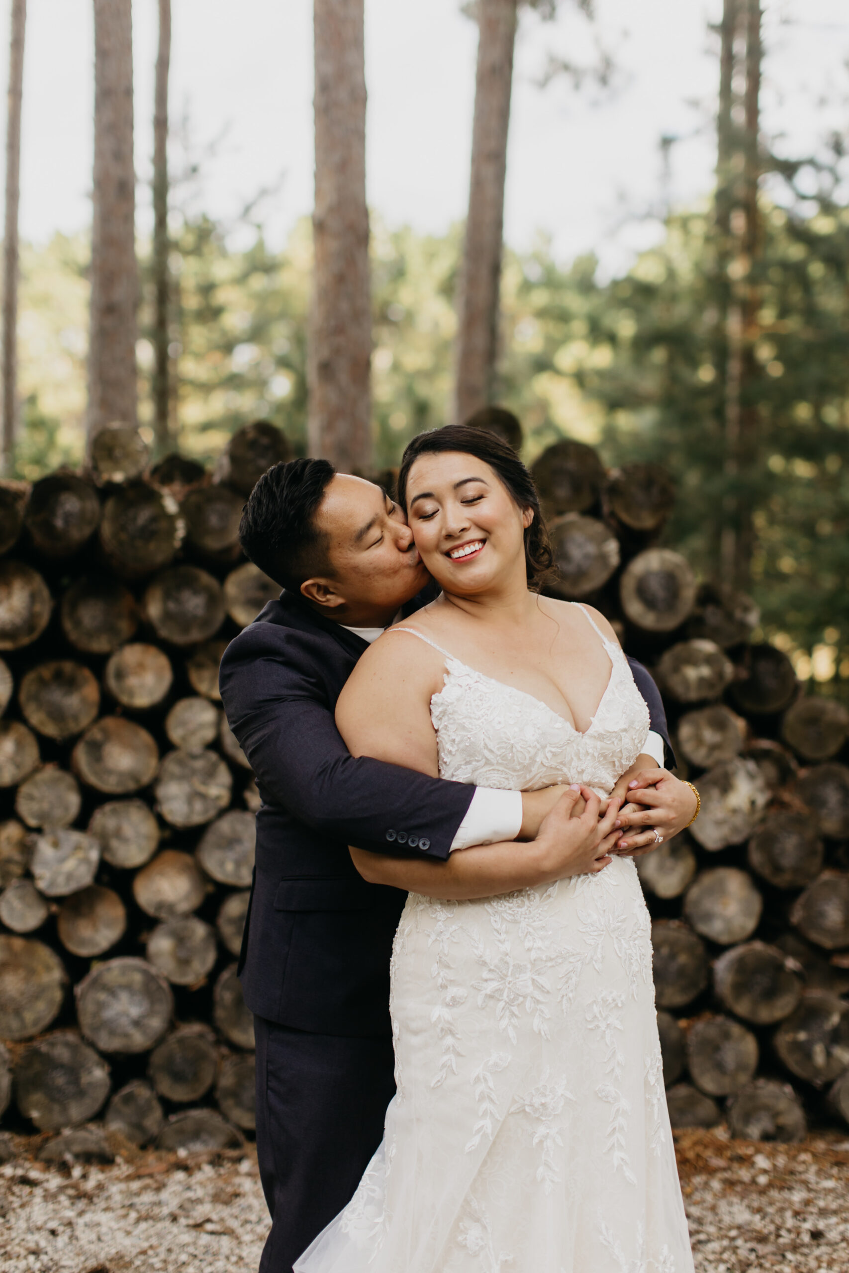 A lovely photo of the newlyweds with pine trees as the background