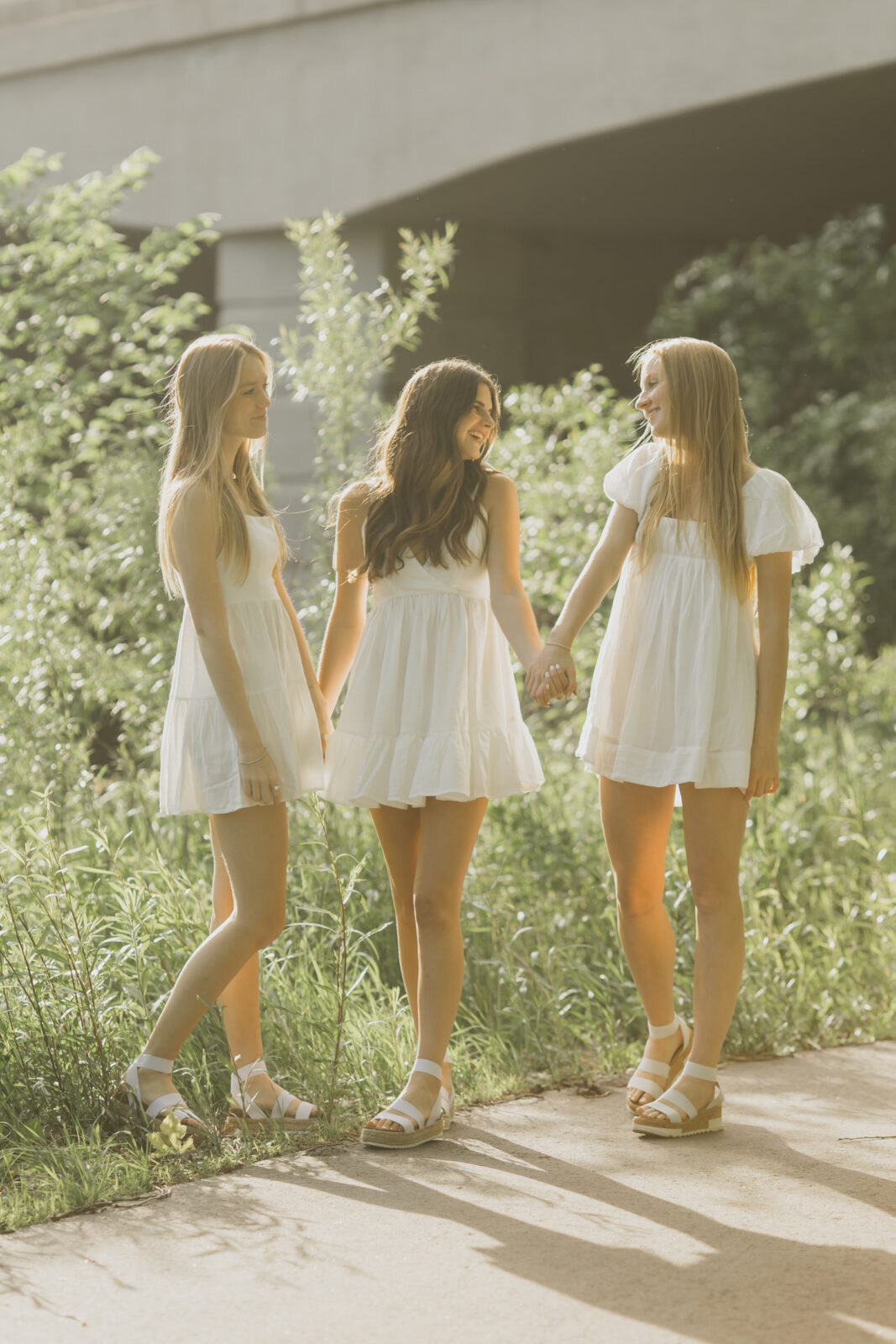 A photo of a raw and lovely moment of the three lovely seniors from Edina High School