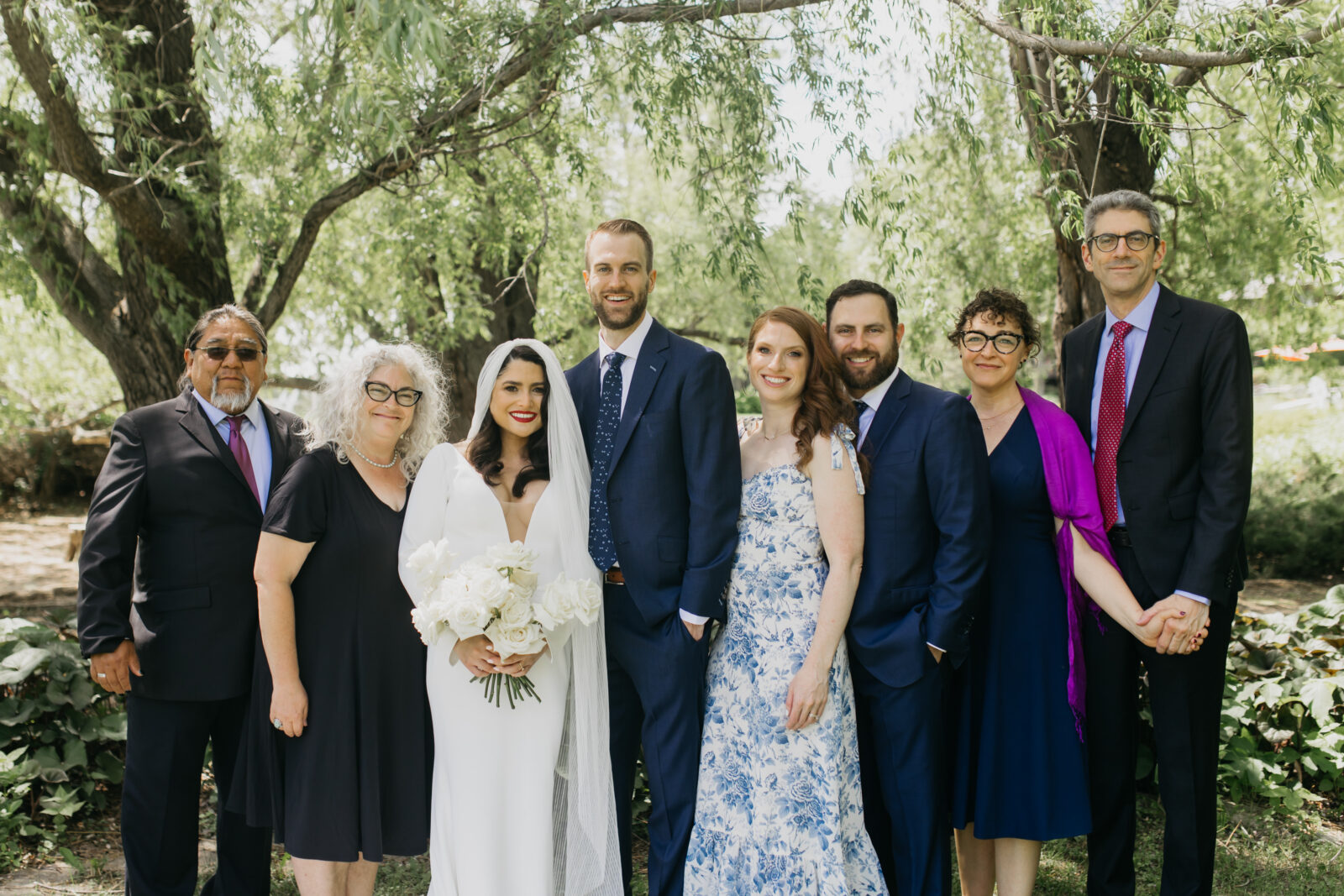A photo of the the bride and groom's respective families during their wedding day