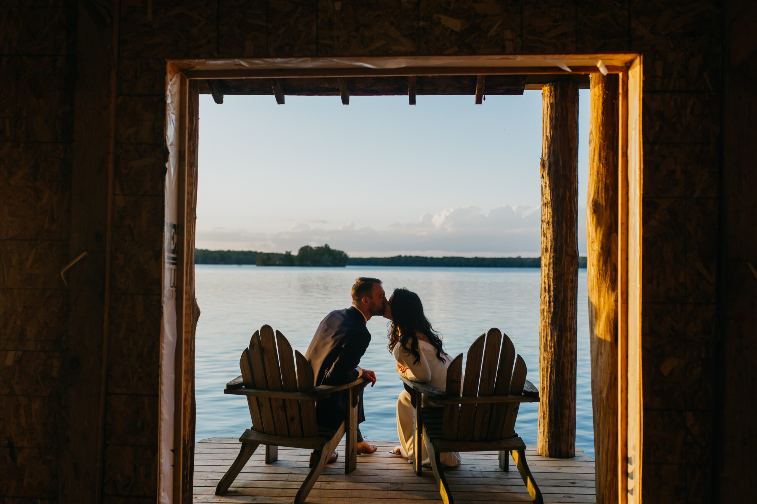 A photo of the lovely bride and groom kissing at The Stout's Island lodge during their wedding day