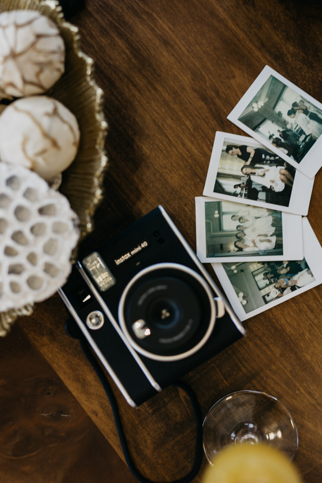 A photo of an instax and 4 polaroids