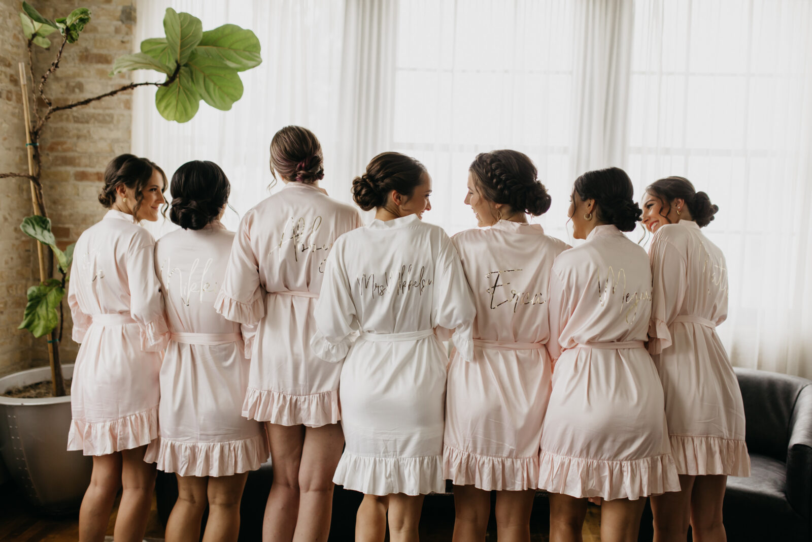 A photo of the bride and her bridesmaids wile preparing for the wedding day