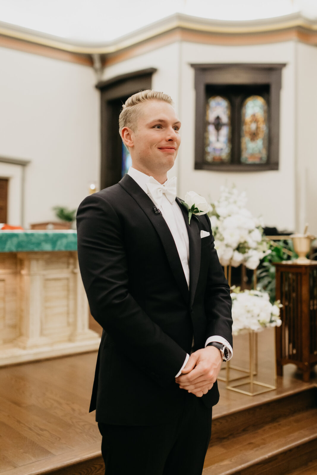 A photo of the groom waiting for the bride on the altar