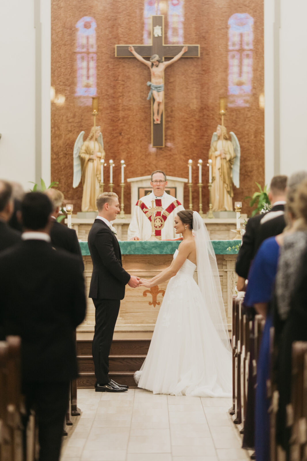 A photo of the bride and groom looking at each other at the altar
