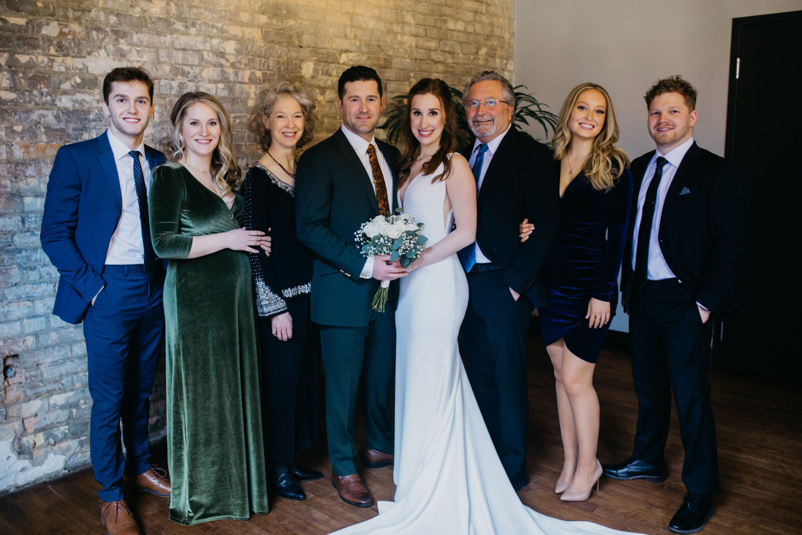 Photo of the bride and groom with their families and friends