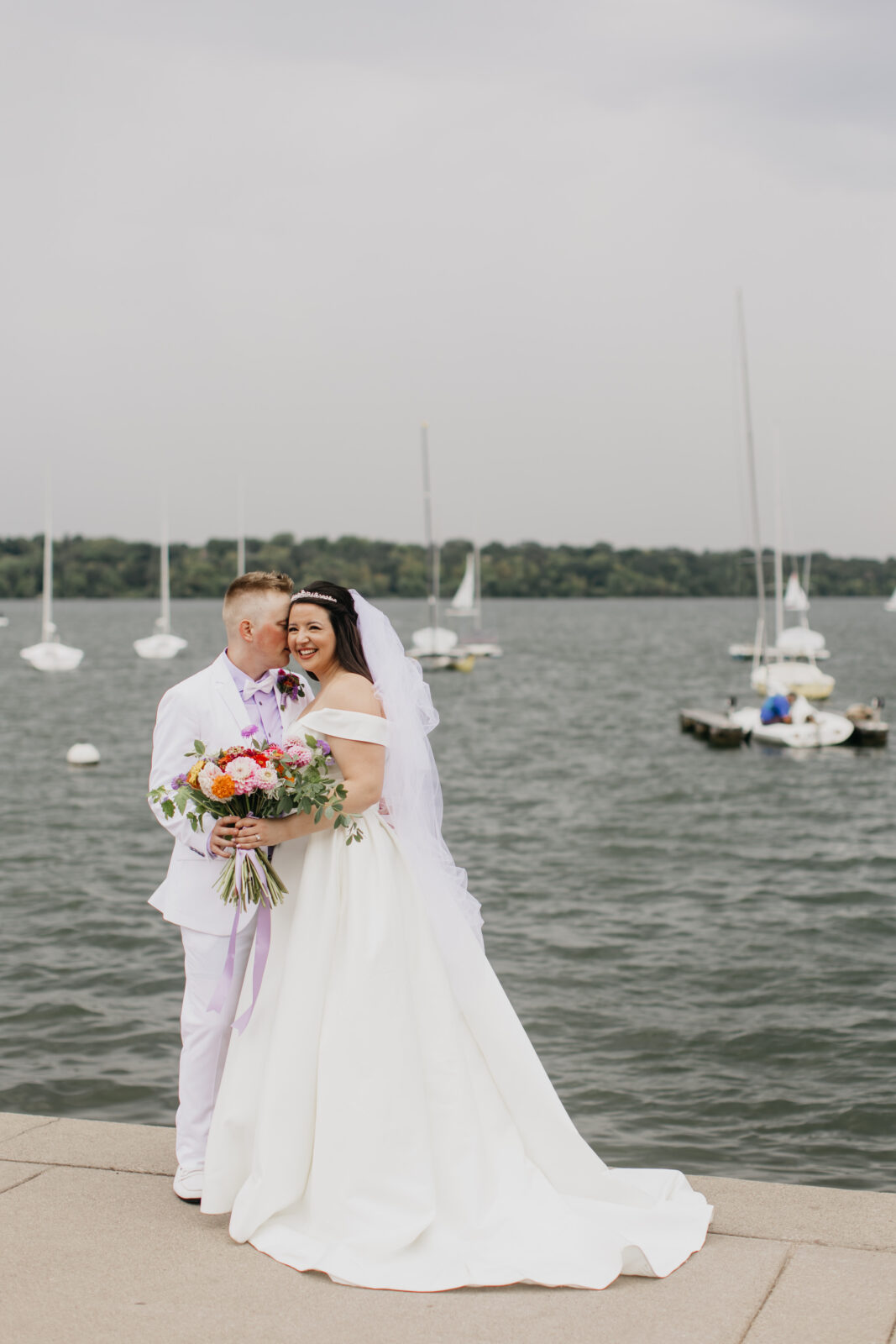 Photo of the bride and groom during their first looks at Lake Harriet