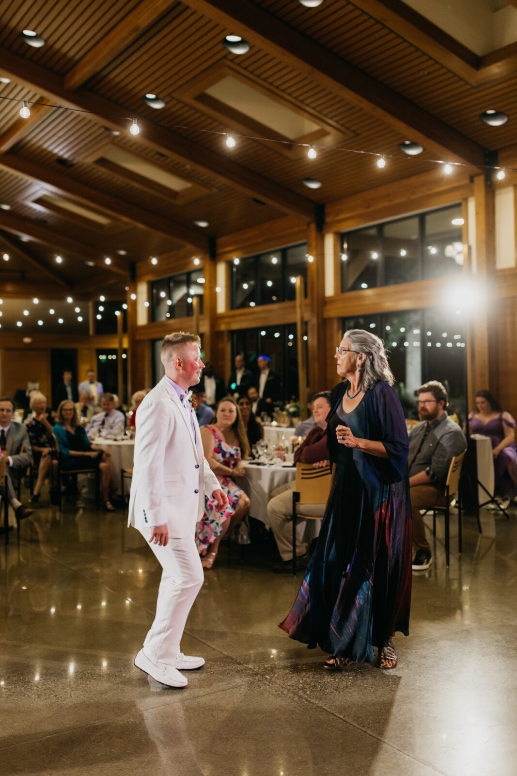 A photo of the groom dancing at the reception