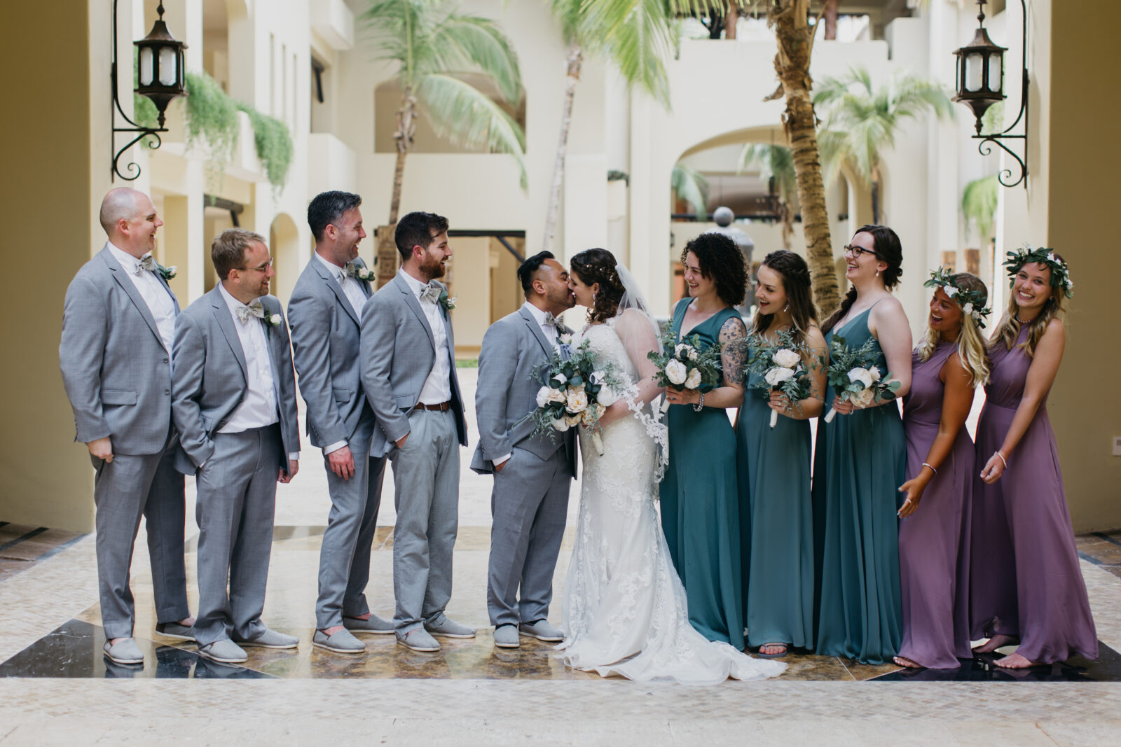 A lovely photo of the bride and groom and their groomsmen and bridesmaids