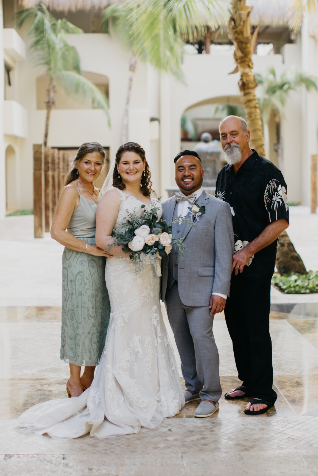 A photo of the wedding couple and the groom's parents