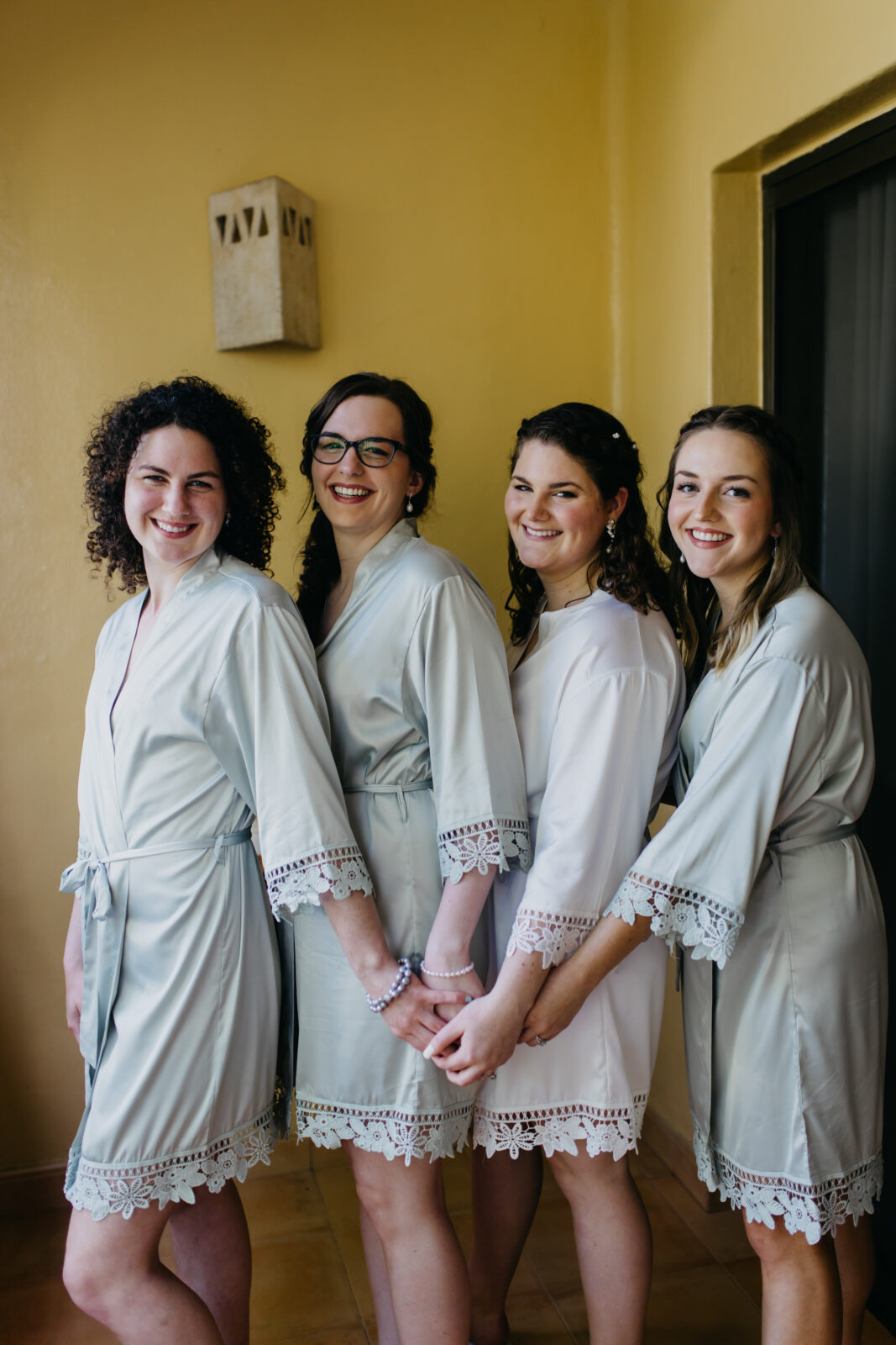 A photo of the bride and bridesmaids preparing