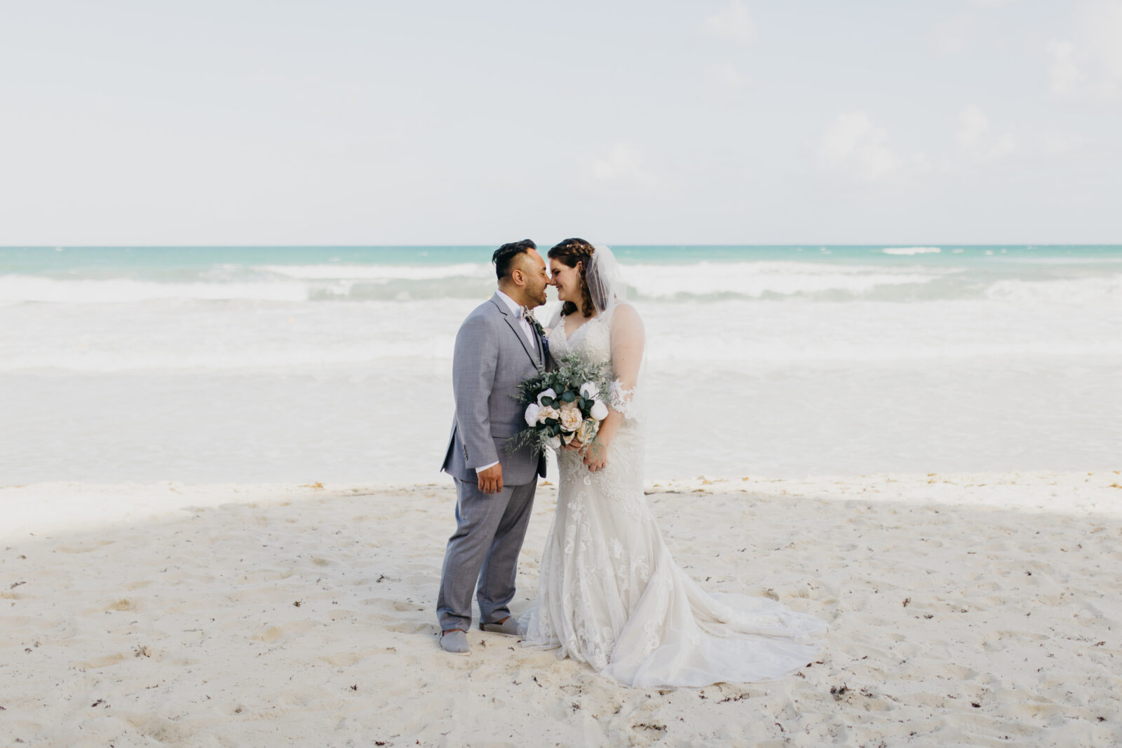 A lovely photo of the bride and groom by the beach in Playa del Carme