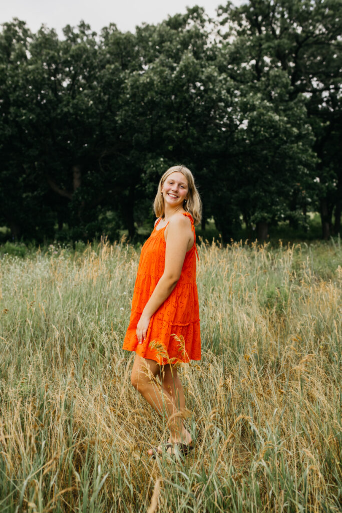 Edina High School Photos of a Senior in a vibrant orange dress