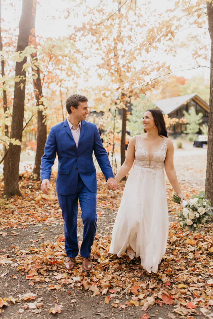A couple happily glancing at each other in their fall wedding shoot