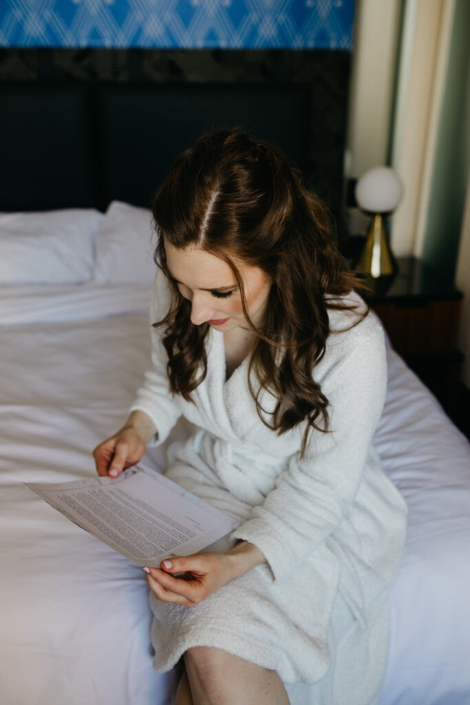 bride reading a letter written by her soon-to-be husband at their wedding day