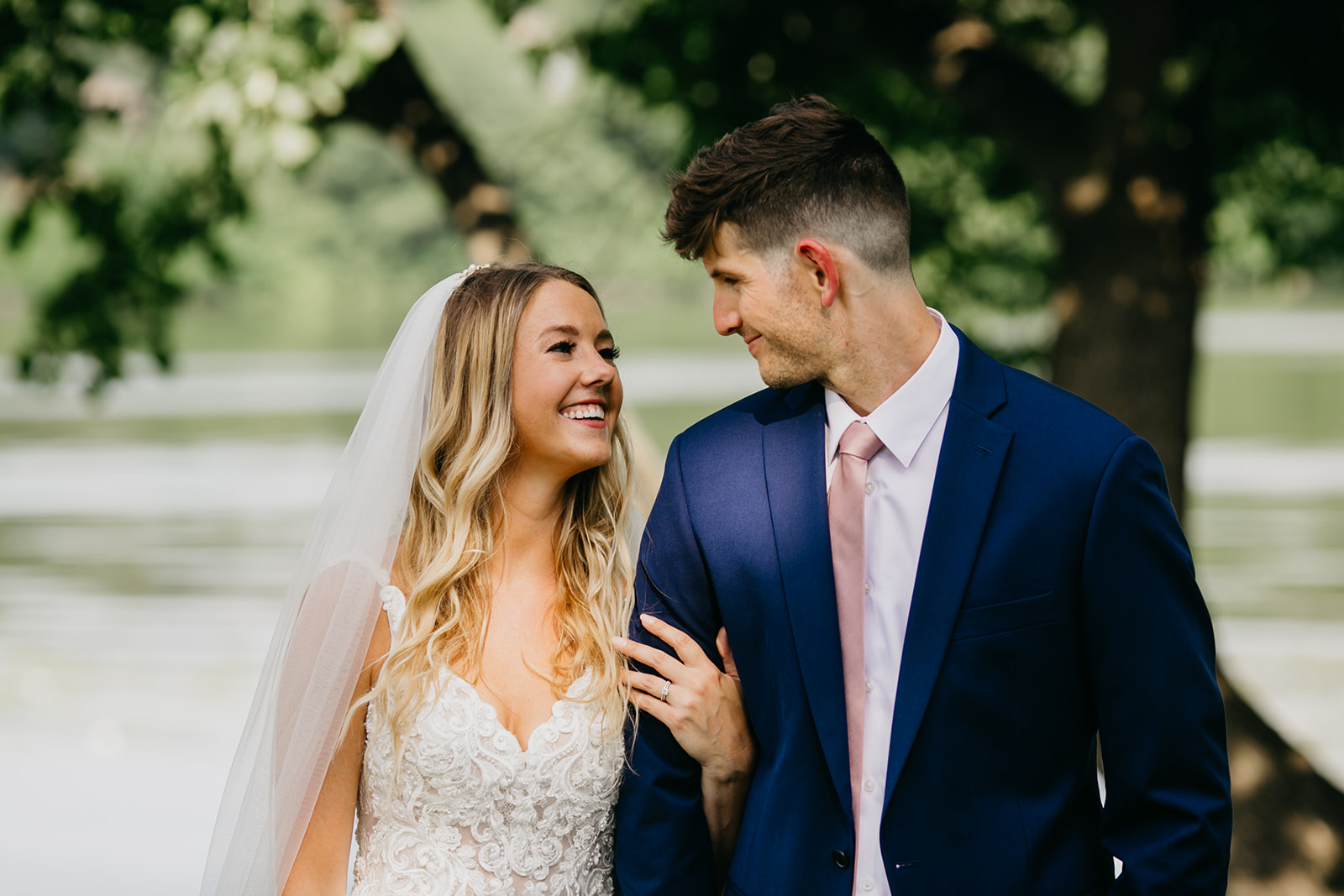 Bride and groom smiling at each other during their wedding day in the heart of Minneapolis photographed by a Minneapolis Elopement Photographer