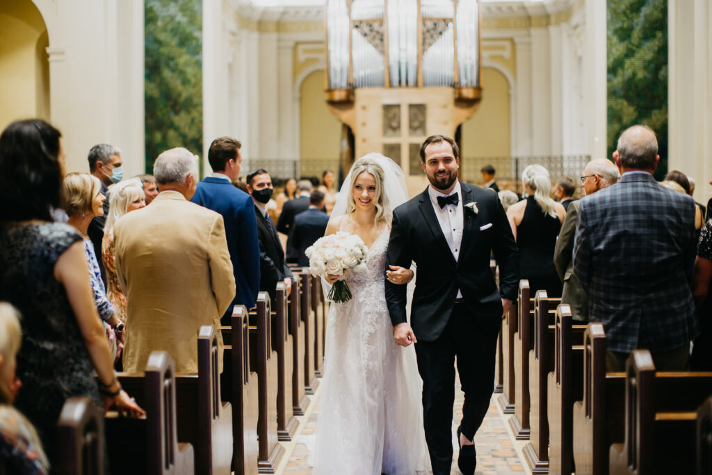 Photo of the bride and groom walking up the aisle after their wedding ceremony