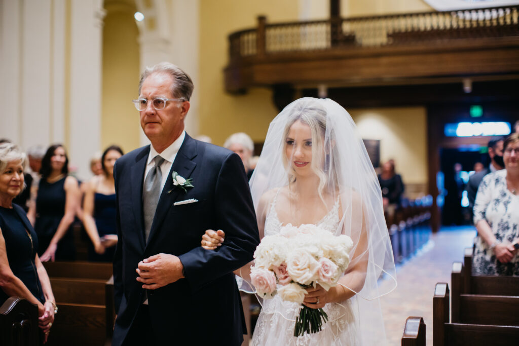 The bride walking down the aisle with her father