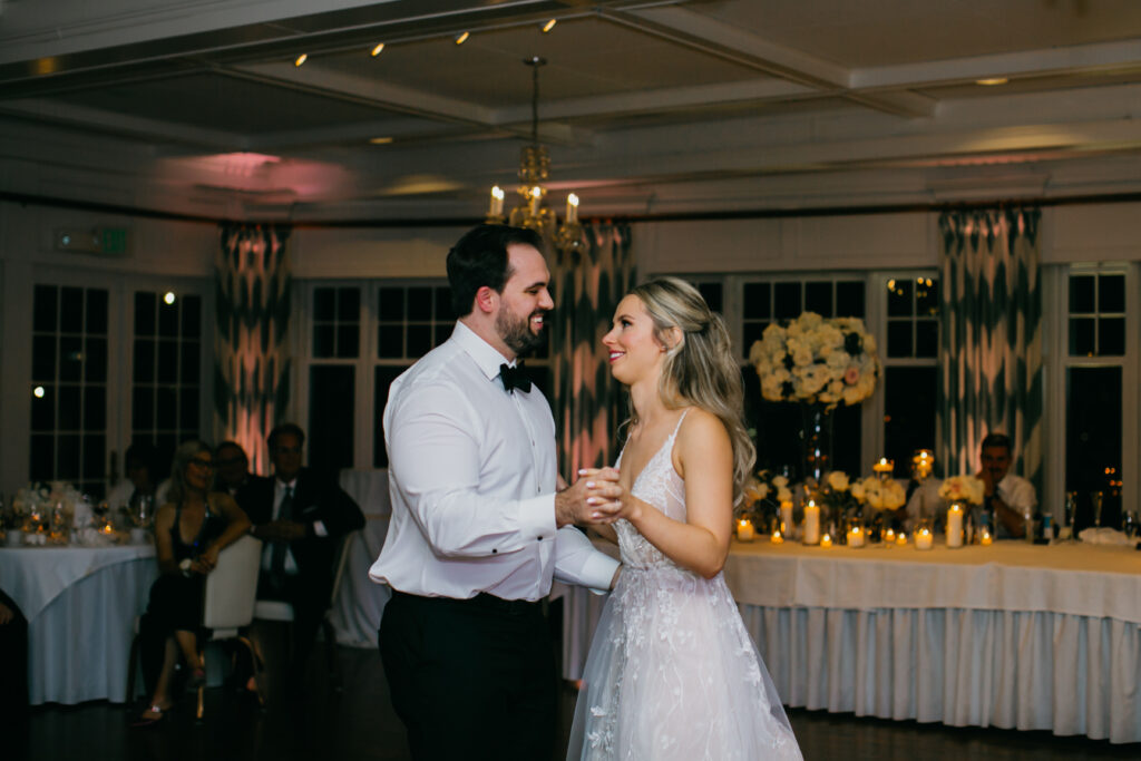 Photo of the bride and groom having their first dance as married couples on their wedding day