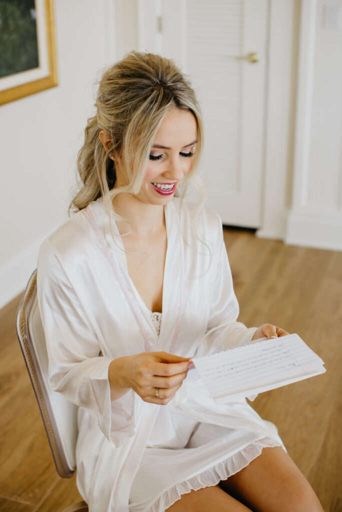 A photo of the bridereading the letter written by the groom during their wedding day