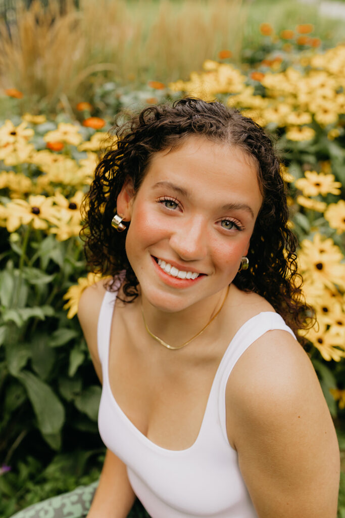 Senior photos of Ali, a senior from Visitation School MN, set in a backdrop of flowers