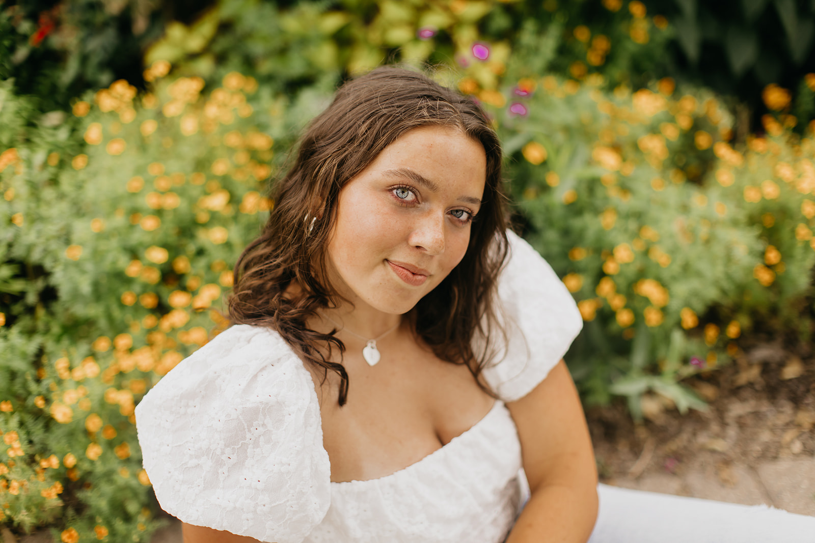 Breck Senior Photos of Eva with flowers as her background