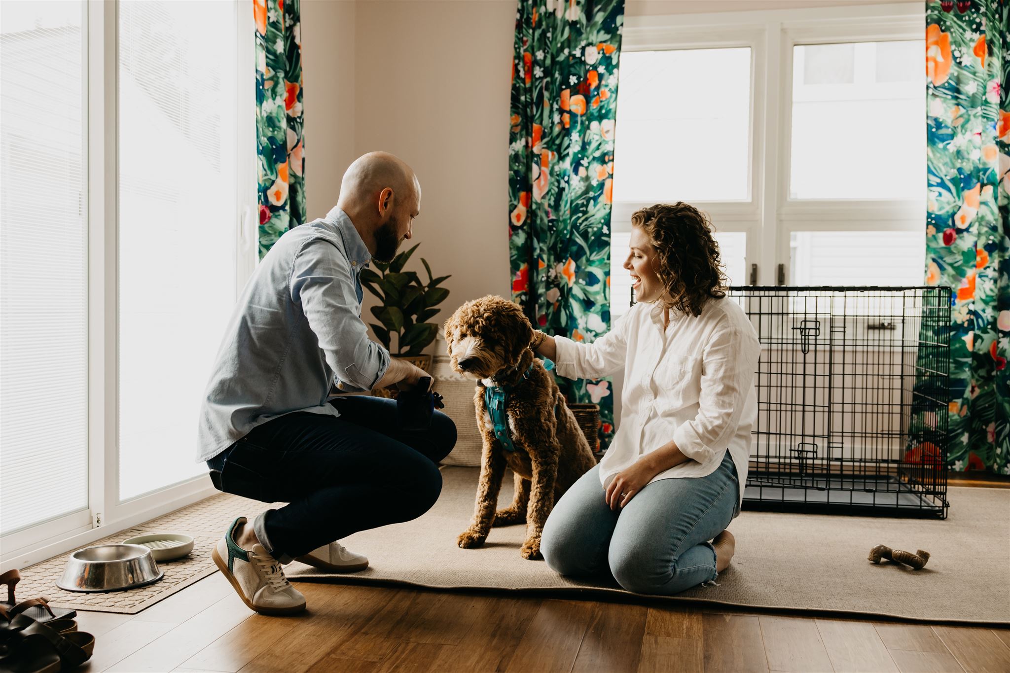 A photo of a lovely couple and their dog in their living room
