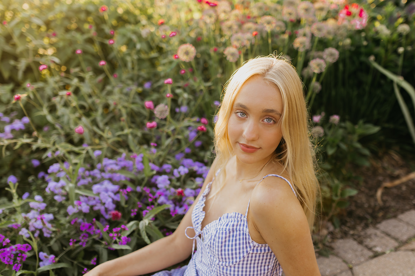 Photo of a high school senior with flowers as the background