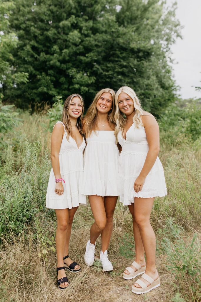 Photo of Edina High School Seniors wearing white dresses on a field