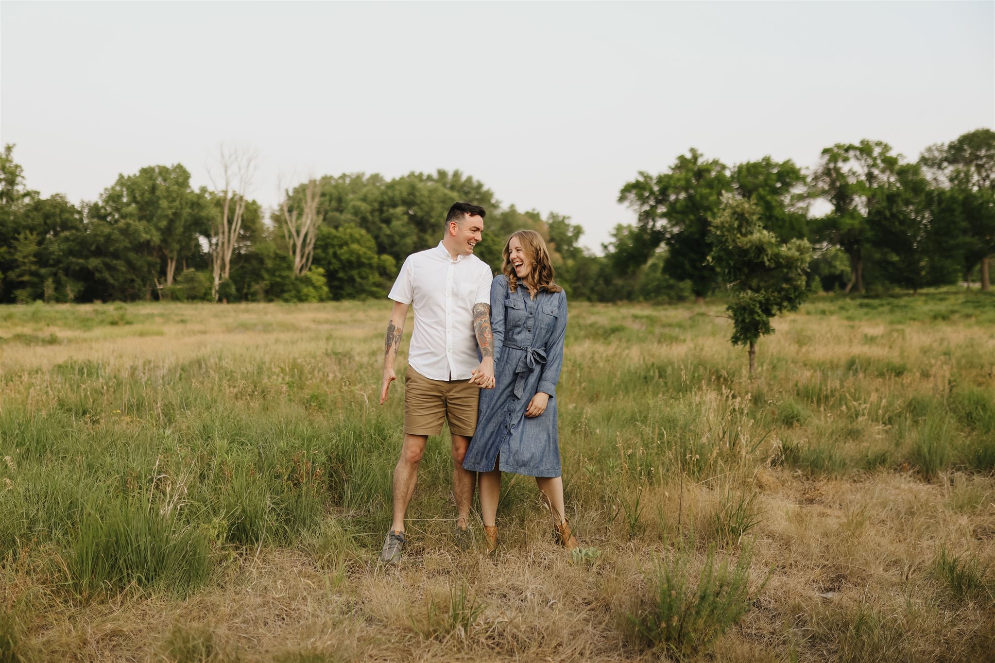 A photo of a couple during their engagement session at the field