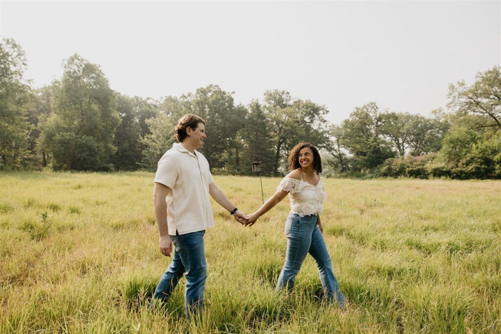 a lovely engagement photo of a couple at the field