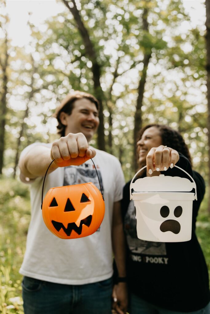 a lovely photo of a couple during their silverwood park engagement photos with their halloween props