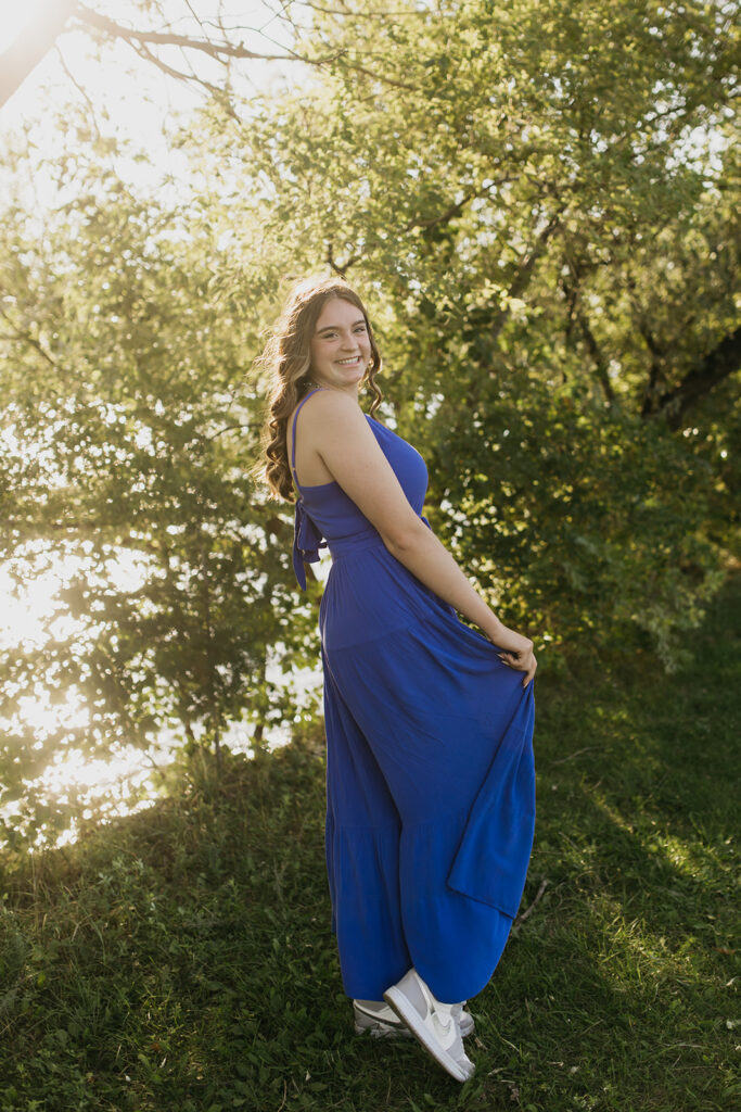 A photo of a senior wearing a blue dress from Visitation High School