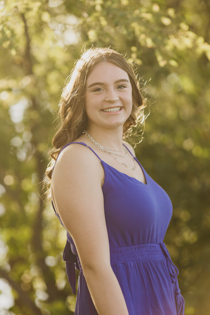A photo of a senior wearing a blue dress from Visitation High School