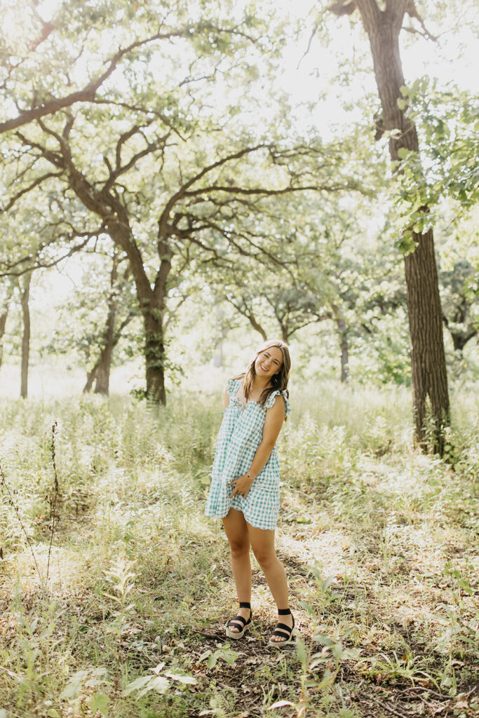 A photo of a visitation school senior with the trees as her background of her shoot
