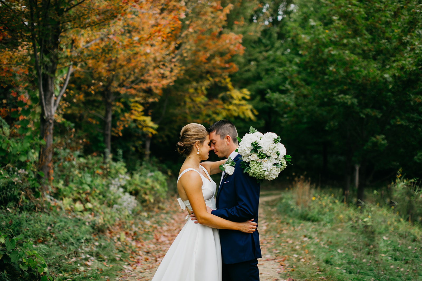 Photo of a newlywed with trees as their background