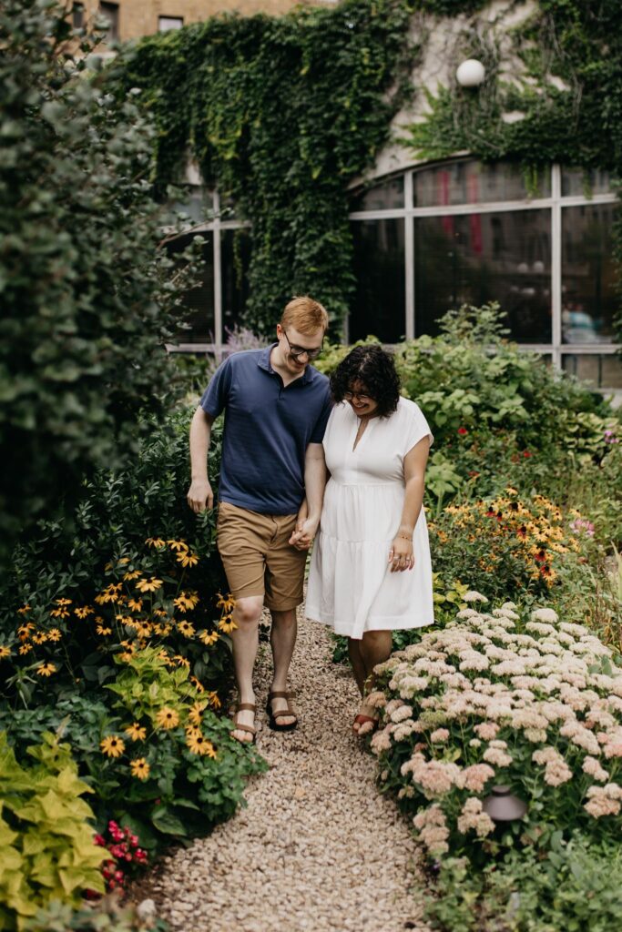 Photo of an engaged couple surrounded by flowers