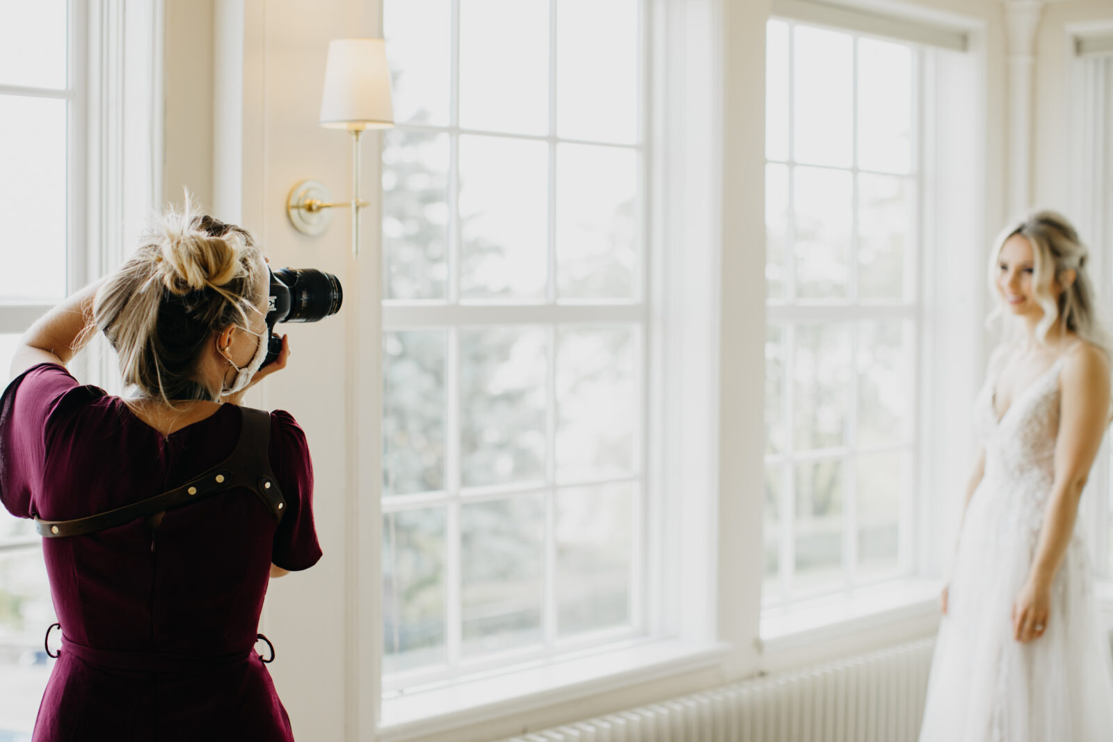 Photo of Mycah Bain photographing a bride during a wedding shoot