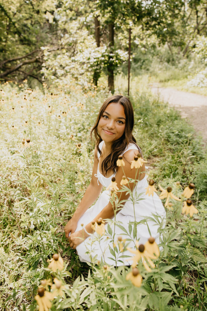 Washburn High School senior posing with summer blooms