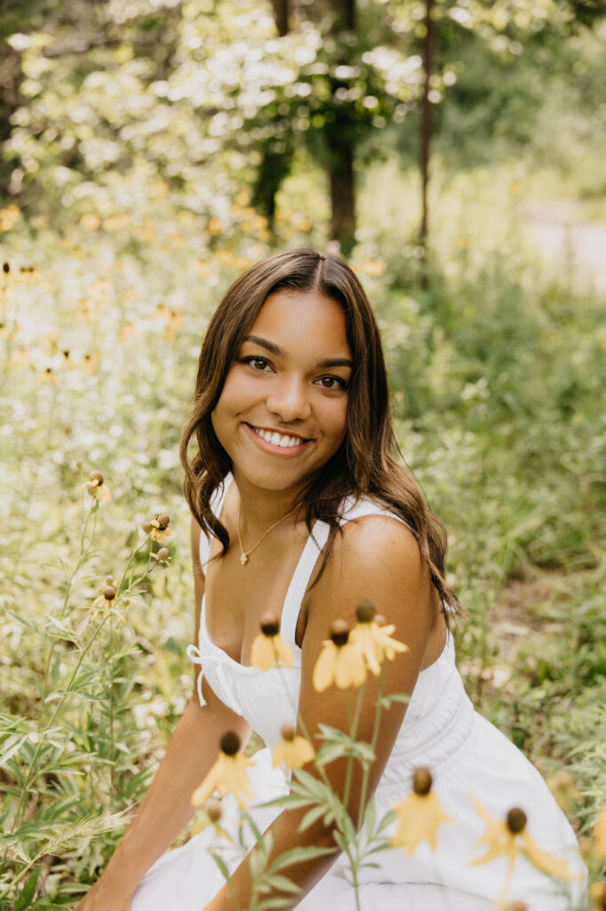 Washburn High School senior posing with summer blooms