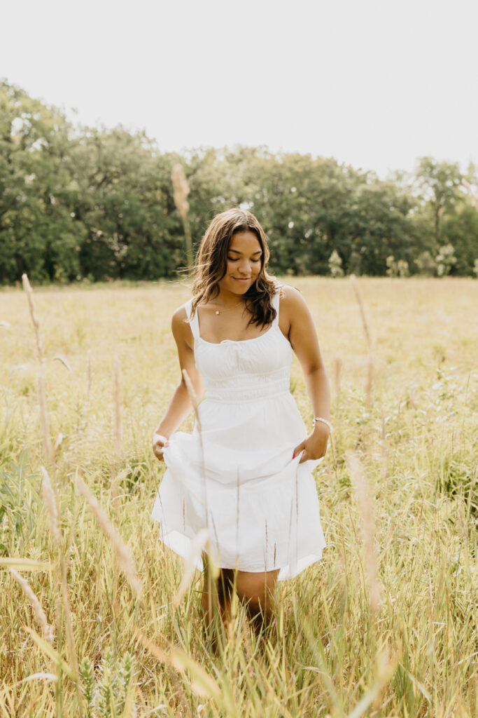 Washburn High School senior posing in the field.