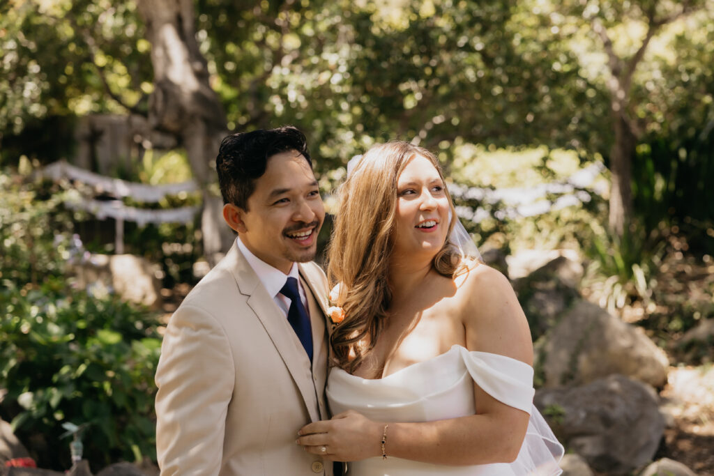 Bride and groom laughing together during their Montecito private estate first look, captured in natural sunlight.