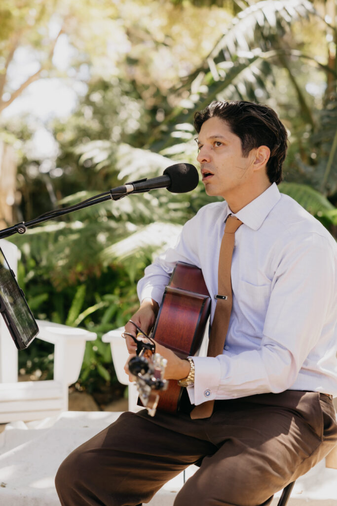 Ceremony musician performing with acoustic guitar during a Montecito private estate wedding.