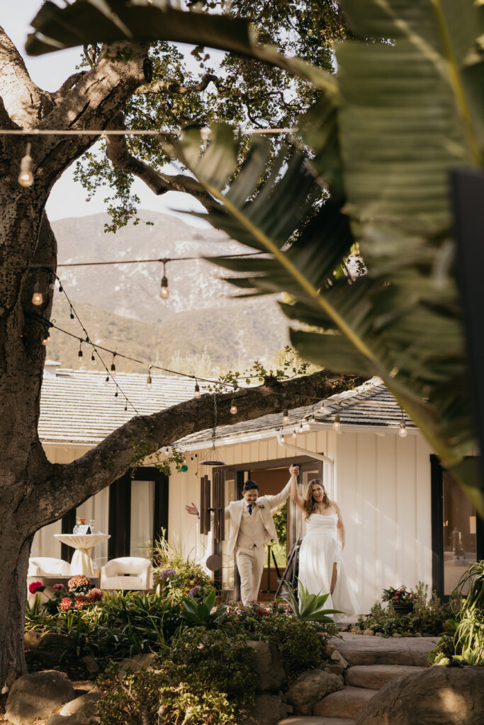 Bride and groom making their grand entrance into the reception at The Cole Home in Montecito.