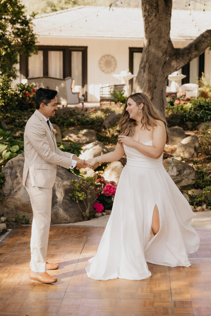 Bride and groom sharing their first dance outdoors on the patio of a Montecito private estate wedding.