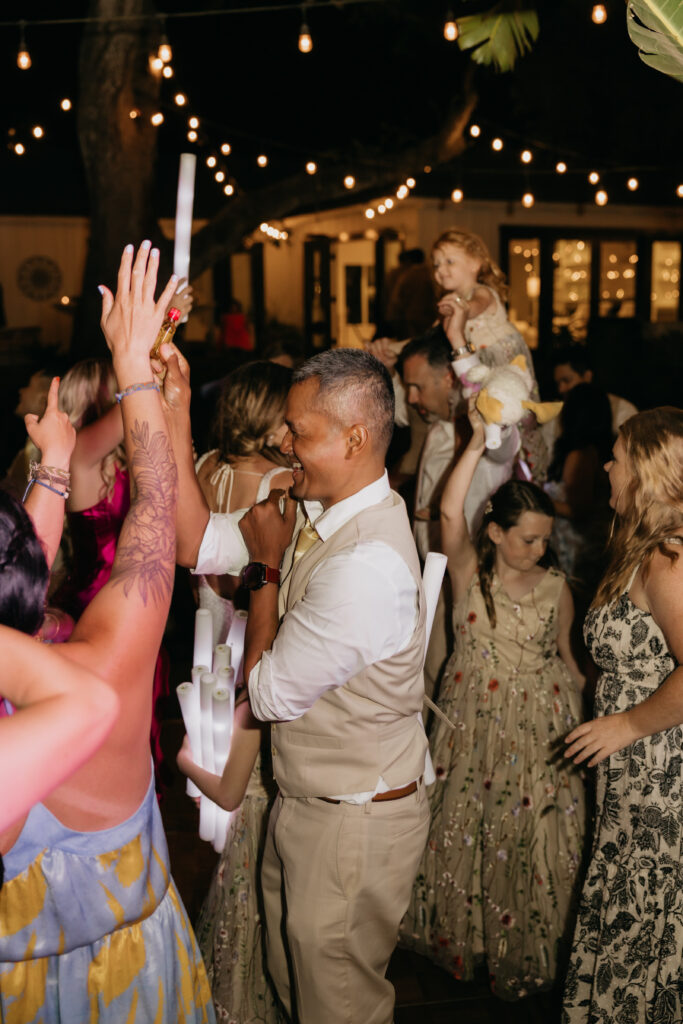 Wedding guests dancing under string lights during a Montecito private estate reception.