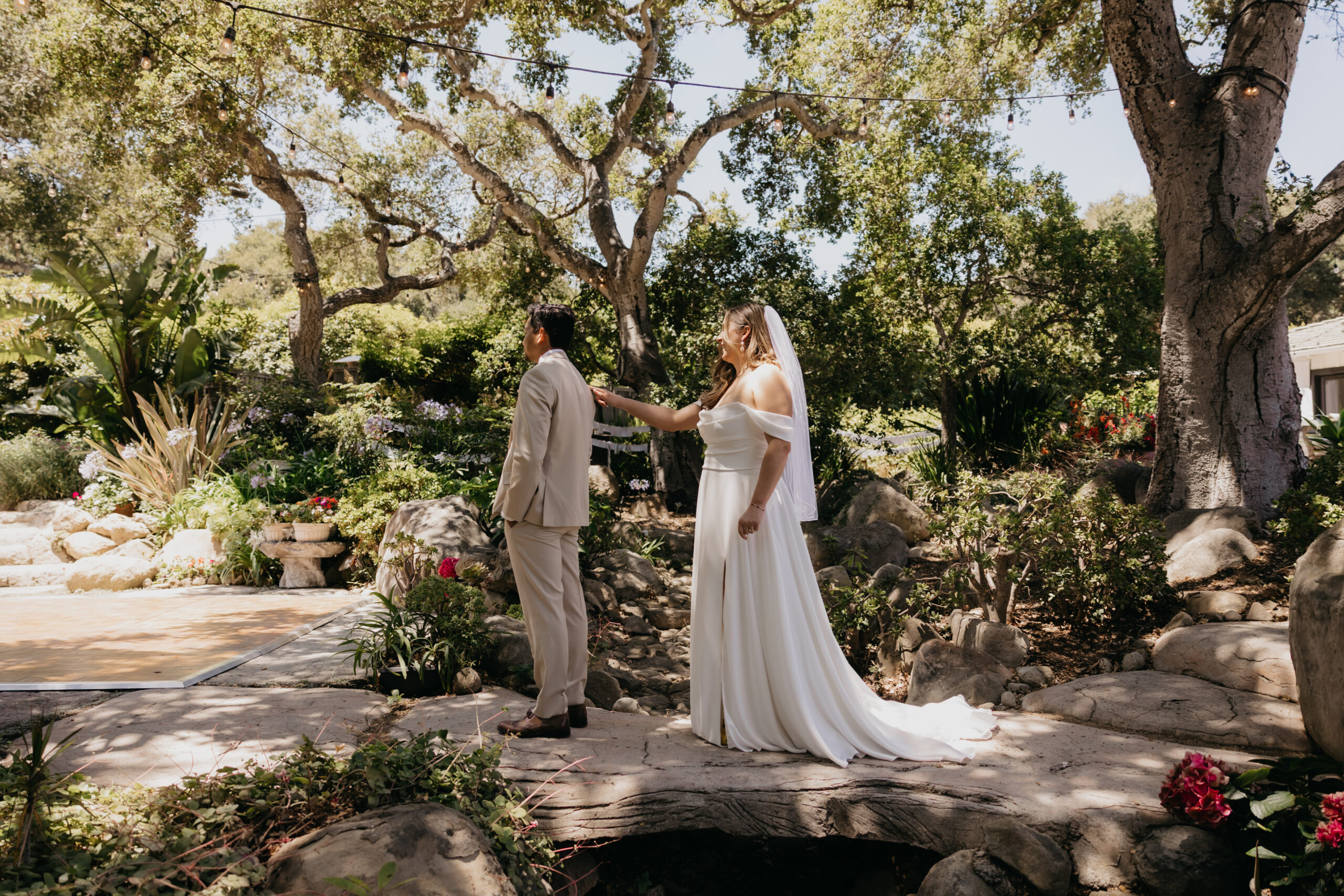Bride and groom first look at a Montecito private estate wedding, surrounded by lush California gardens.