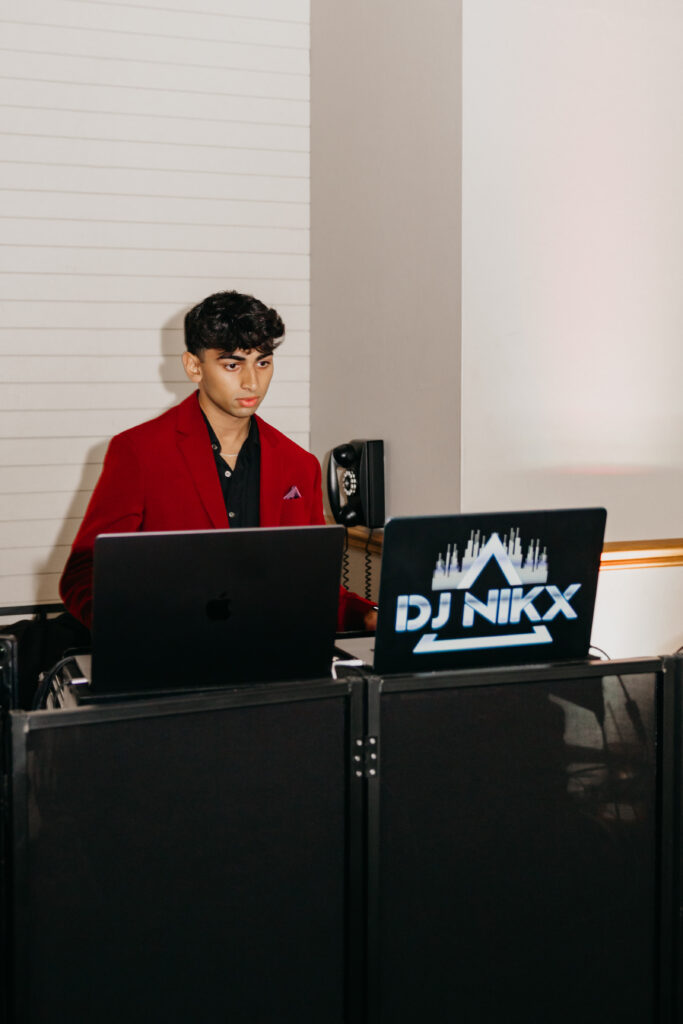DJ Nikx performing at Apoorva and Sanjay’s Indian wedding reception in Minneapolis, captured by Mycah Bain Photography.