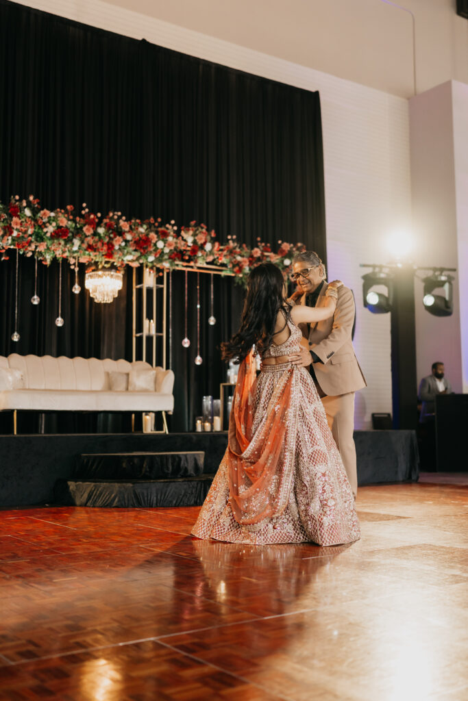 Groom Sanjay dancing with his mother during Indian wedding reception at Renaissance Depot Minneapolis | Mycah Bain Photography, traditional wedding photographer.